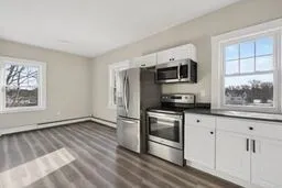 a kitchen with stainless steel appliances a stove a microwave and sink