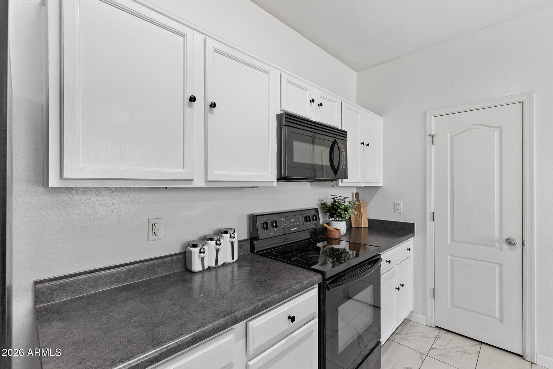 8189 West Groom Creek Road Phoenix, AZ 85043 - Photo 17 of 37 a kitchen with stainless steel appliances granite countertop white cabinets sink and dishwasher