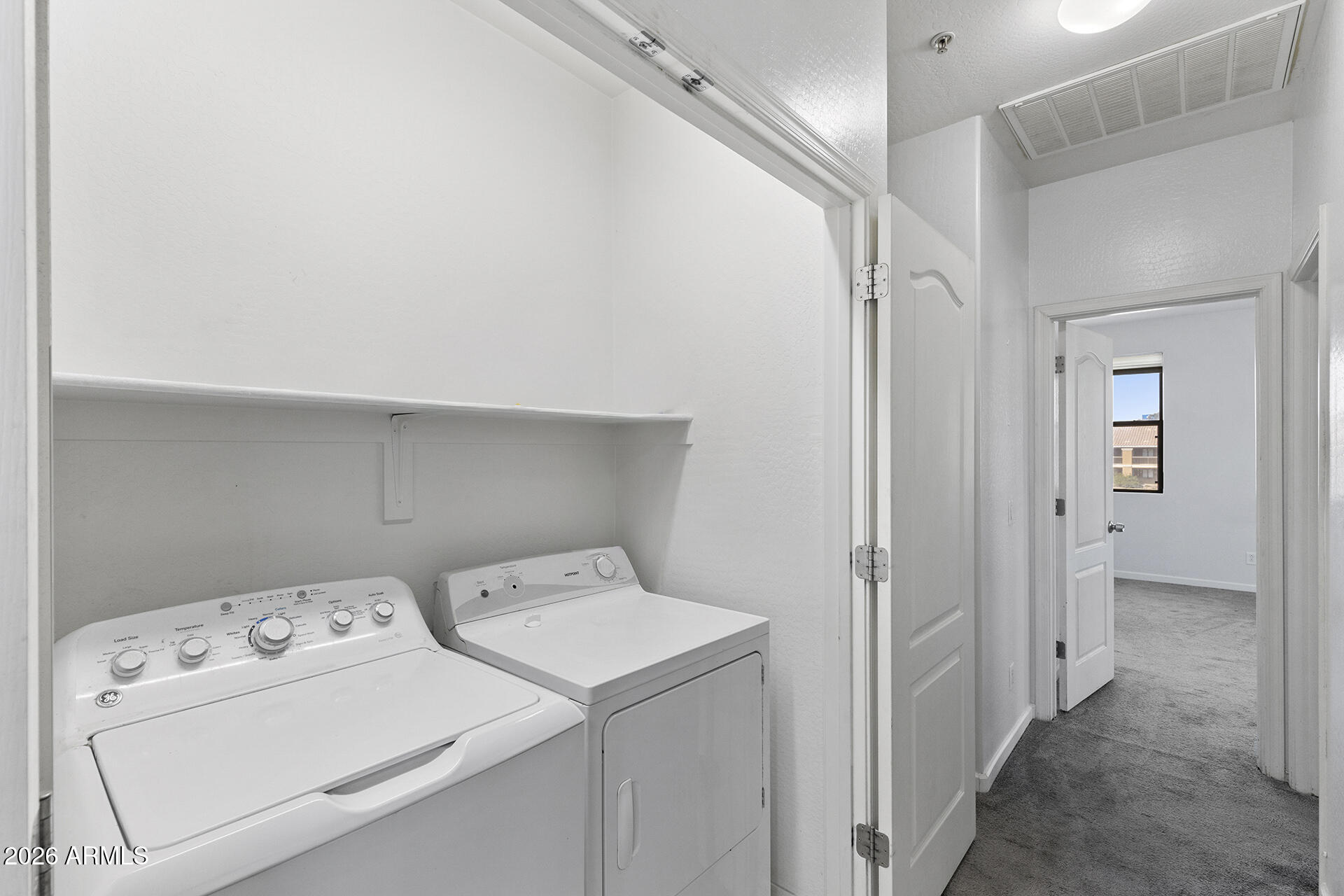 8189 West Groom Creek Road Phoenix, AZ 85043 - Photo 23 of 37 a view of storage and utility room with washer and dryer
