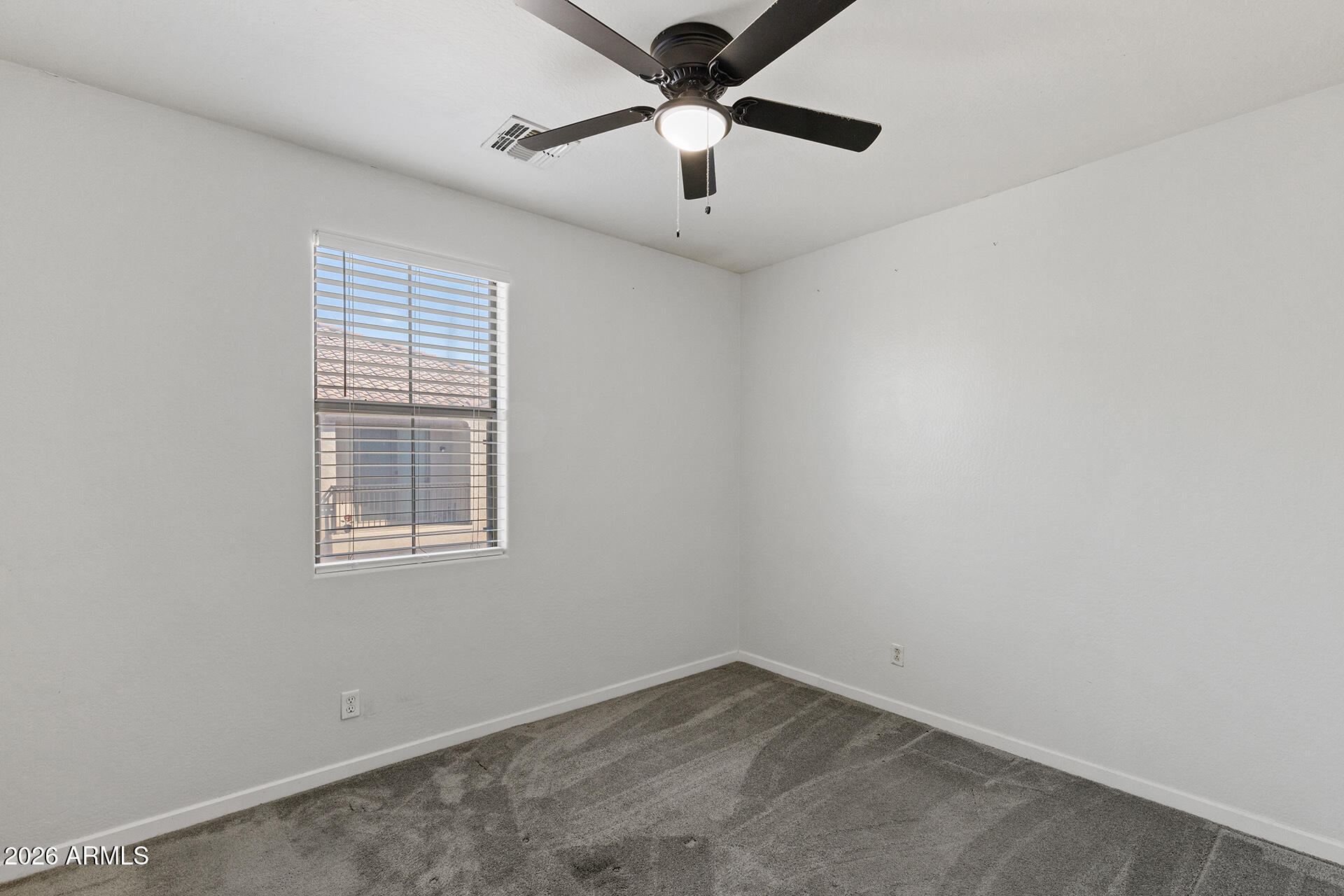 8189 West Groom Creek Road Phoenix, AZ 85043 - Photo 25 of 37 an empty room with a window and a fan