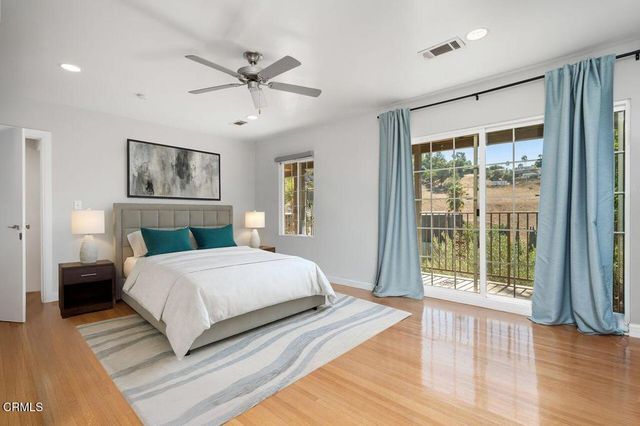 a bedroom with a large bed and a large window