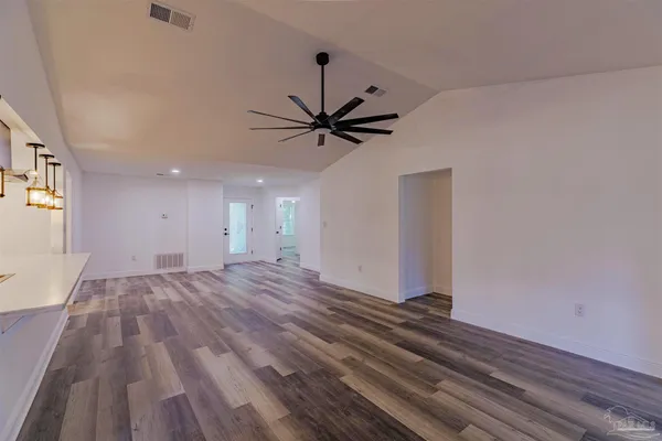a view of a livingroom with a hardwood floor and a ceiling fan