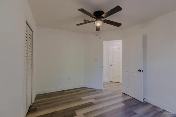 a view of an empty room and wooden floor
