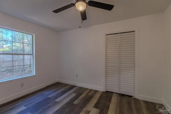 a bathroom with a bathtub shower sink vanity mirror and toilet