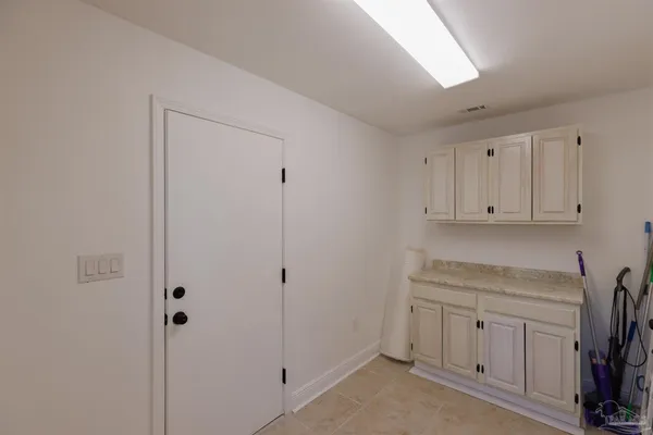 a view of a room with wooden floor and furniture