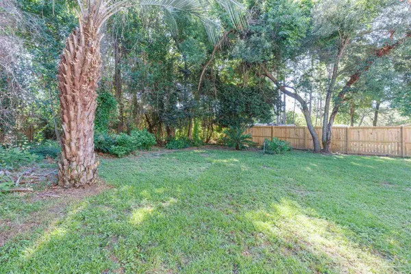 a view of a yard with a house in the background