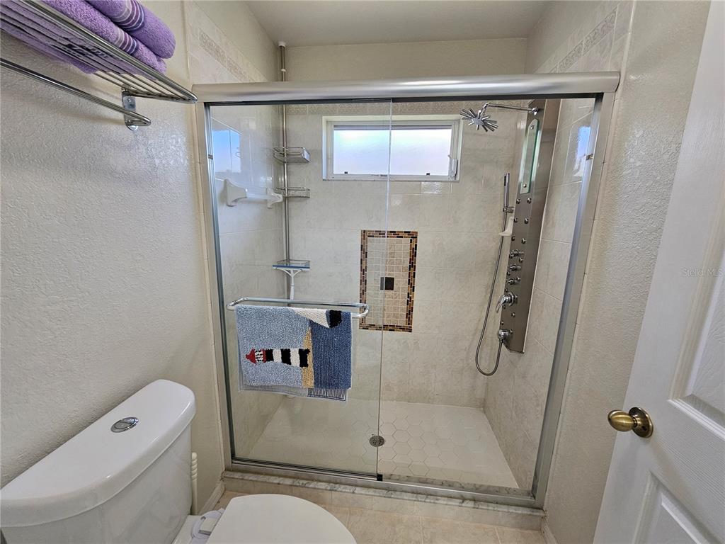 114 Albatross Road Rotonda West, FL 33947 - Photo 21 of 36 a bathroom with a shower and a toilet