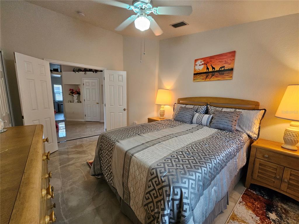 114 Albatross Road Rotonda West, FL 33947 - Photo 24 of 36 a bedroom with bed and window