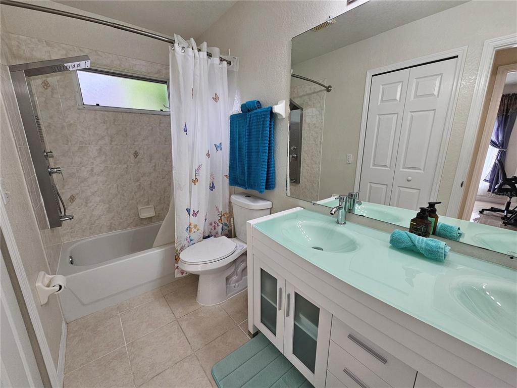 114 Albatross Road Rotonda West, FL 33947 - Photo 25 of 36 a bathroom with a granite countertop sink toilet and shower