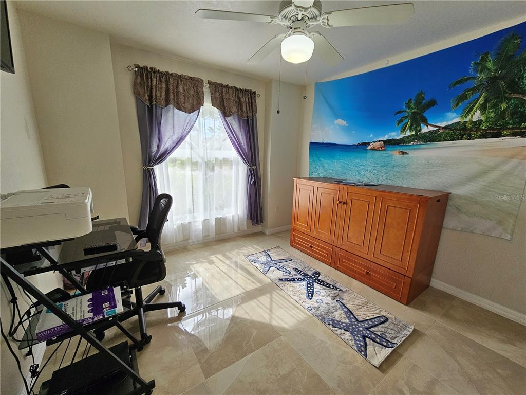 114 Albatross Road Rotonda West, FL 33947 - Photo 27 of 36 a bedroom with furniture and window