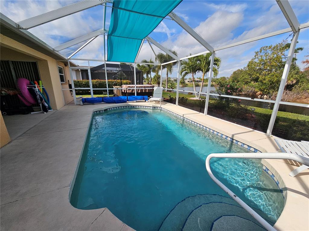 114 Albatross Road Rotonda West, FL 33947 - Photo 32 of 36 a view of a swimming pool with a patio