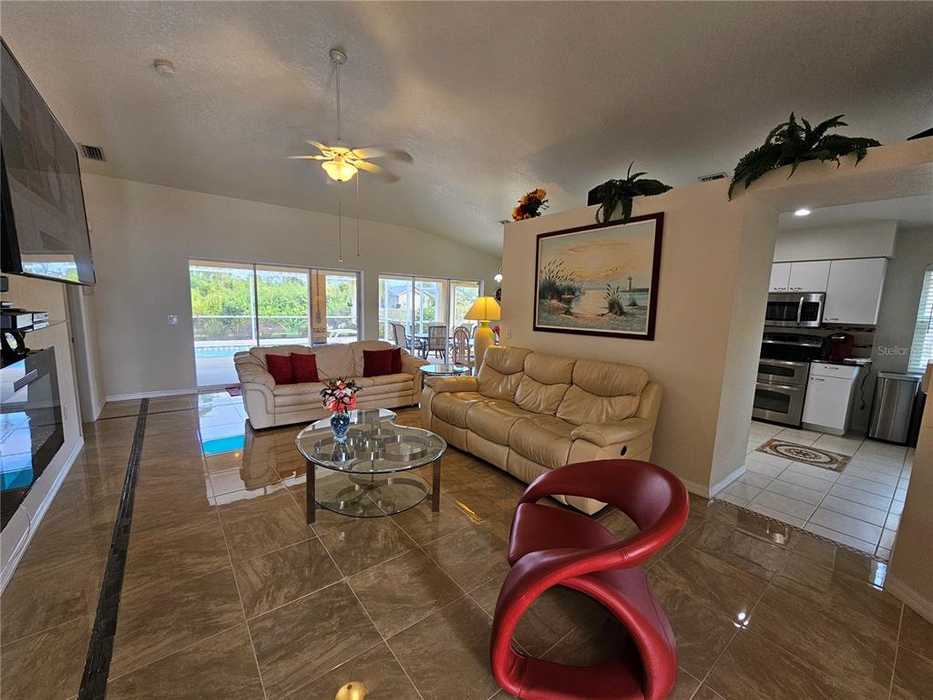 114 Albatross Road Rotonda West, FL 33947 - Photo 4 of 36 a living room with furniture and a flat screen tv