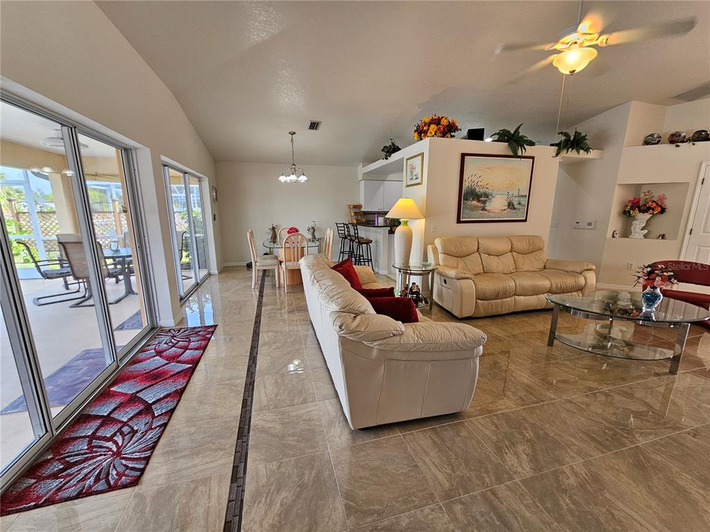 114 Albatross Road Rotonda West, FL 33947 - Photo 6 of 36 a living room with furniture and a flat screen tv