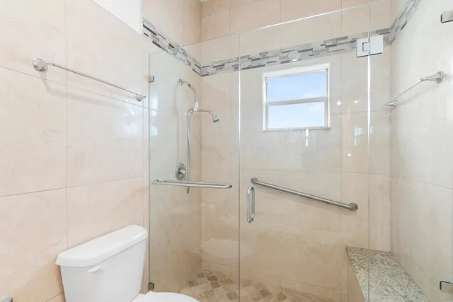 a bathroom with a shower and a toilet