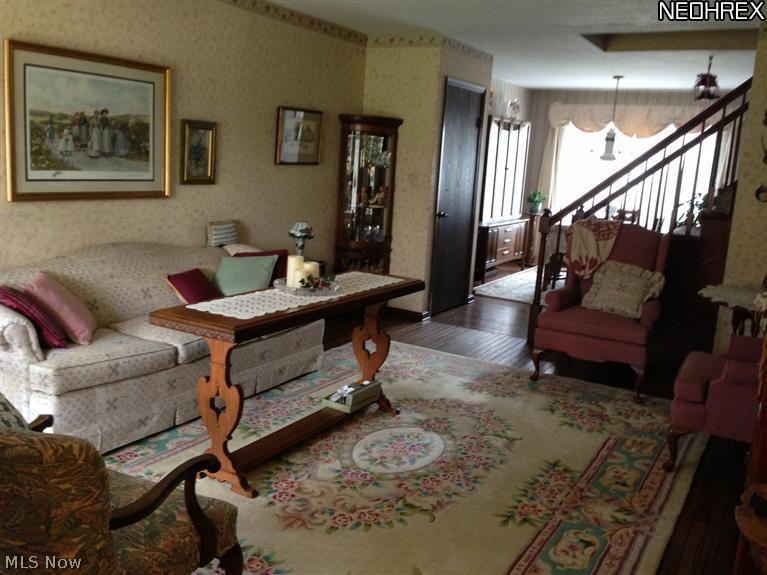 4735-4739 West Mill Road Broadview Heights, OH 44147 - Photo 3 of 22 Elegant living room with foyer entrance, rich hardwood floor and open staircase.