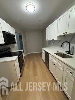 a kitchen with a sink and cabinets