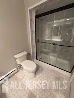 a bathroom with a toilet and a shower