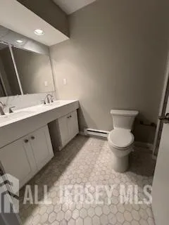 a bathroom with a toilet sink and mirror