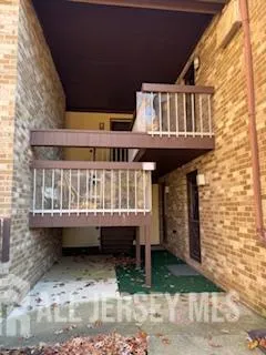a view of a house with a wooden deck
