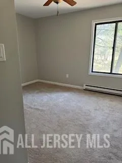 a view of a room with a ceiling fan