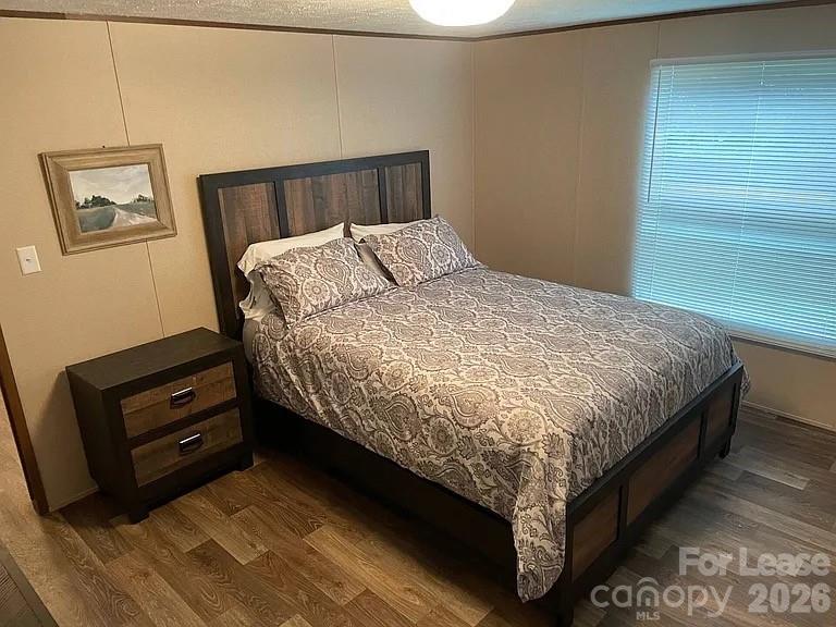 3298 Pea Ridge Road Mill Spring, NC 28756 - Photo 5 of 7 a bed sitting in a bedroom next to a window with a dresser