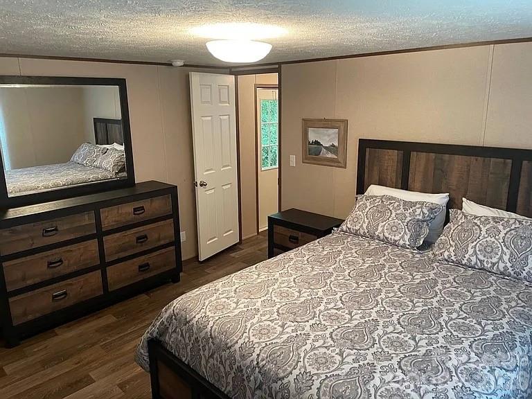 3298 Pea Ridge Road Mill Spring, NC 28756 - Photo 6 of 7 a bed sitting in a bedroom and mirror