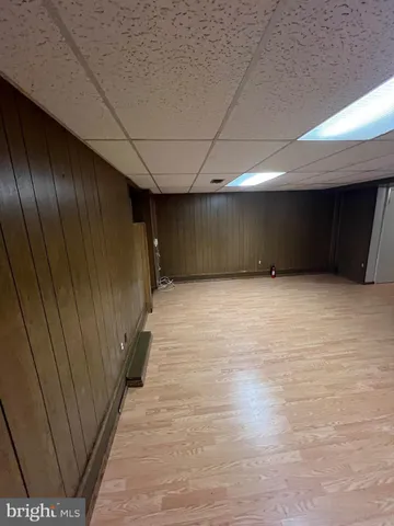 a view of an empty room with a fireplace and a window