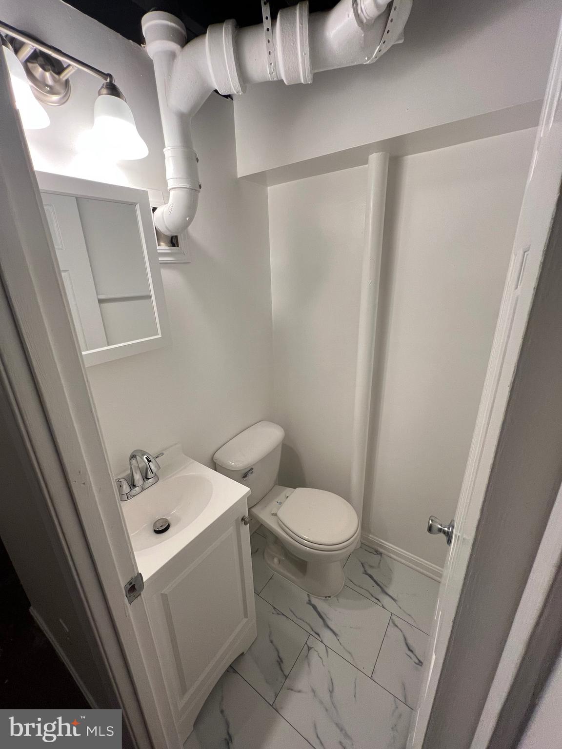 5805 Morningbird Lane Columbia, MD 21045 - Photo 23 of 26 a bathroom with a sink a toilet and shower