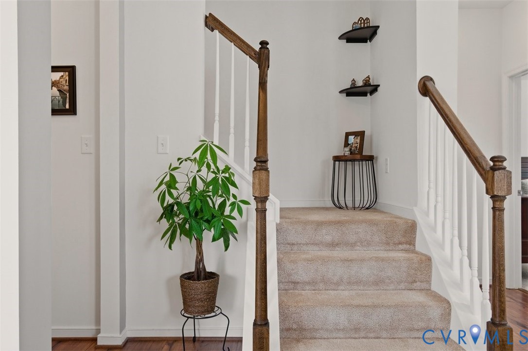 12813 Deep Wl Road Midlothian, VA 23112 - Photo 12 of 35 a vase of flowers sitting on a table with a potted plant