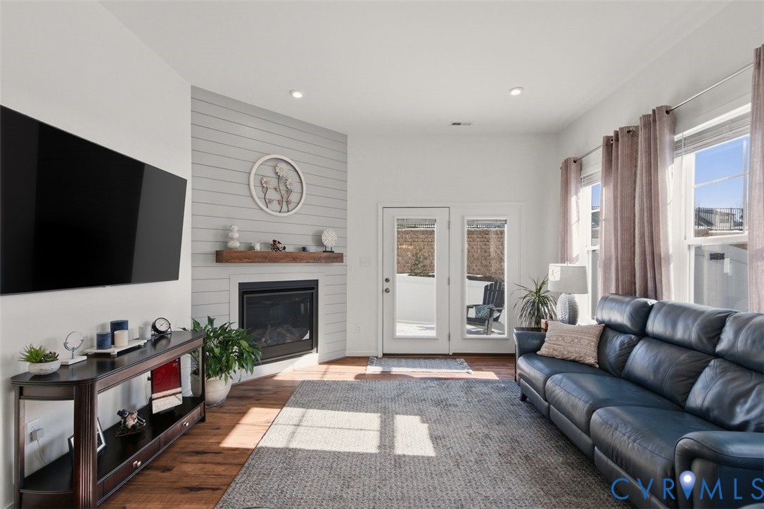 12813 Deep Wl Road Midlothian, VA 23112 - Photo 15 of 35 a living room with furniture a flat screen tv and a fireplace