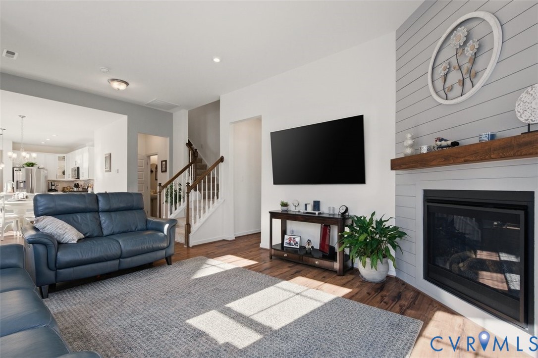12813 Deep Wl Road Midlothian, VA 23112 - Photo 16 of 35 a living room with furniture a flat screen tv and a fireplace