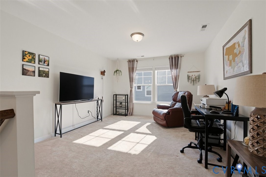 12813 Deep Wl Road Midlothian, VA 23112 - Photo 23 of 35 a living room with furniture and a flat screen tv