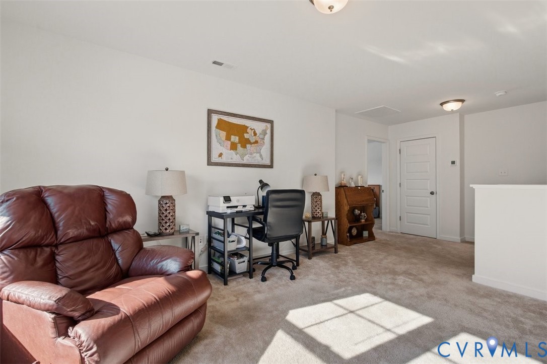 12813 Deep Wl Road Midlothian, VA 23112 - Photo 24 of 35 a living room with furniture and a refrigerator