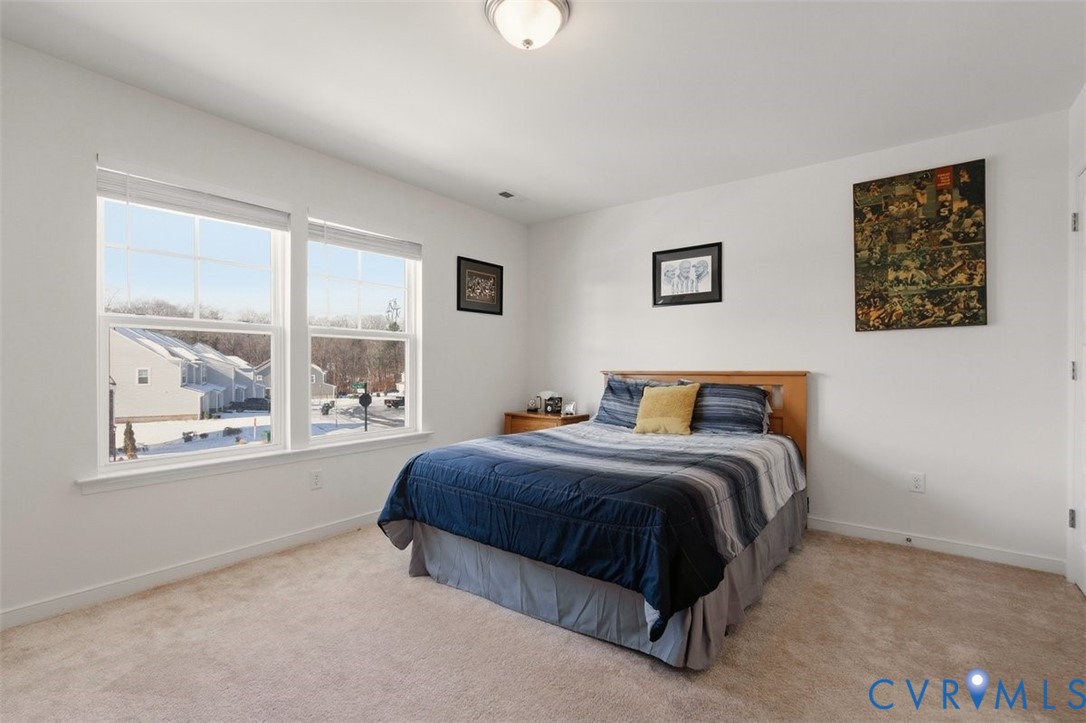 12813 Deep Wl Road Midlothian, VA 23112 - Photo 25 of 35 a spacious bedroom with a bed and a window