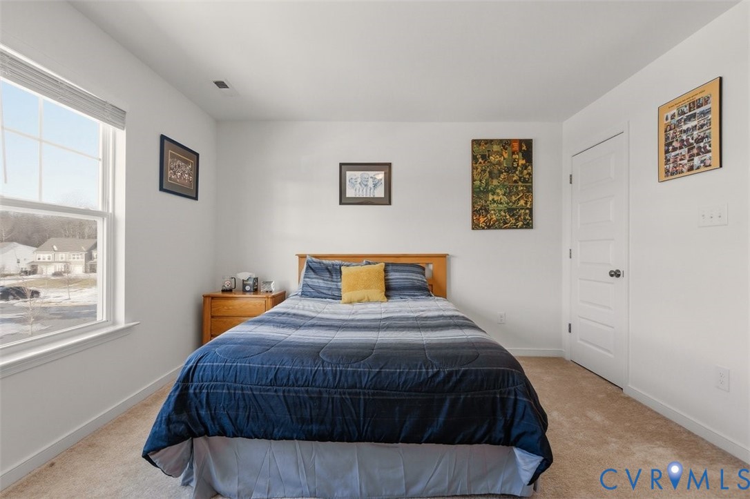 12813 Deep Wl Road Midlothian, VA 23112 - Photo 26 of 35 a bedroom with a bed and painting on the wall