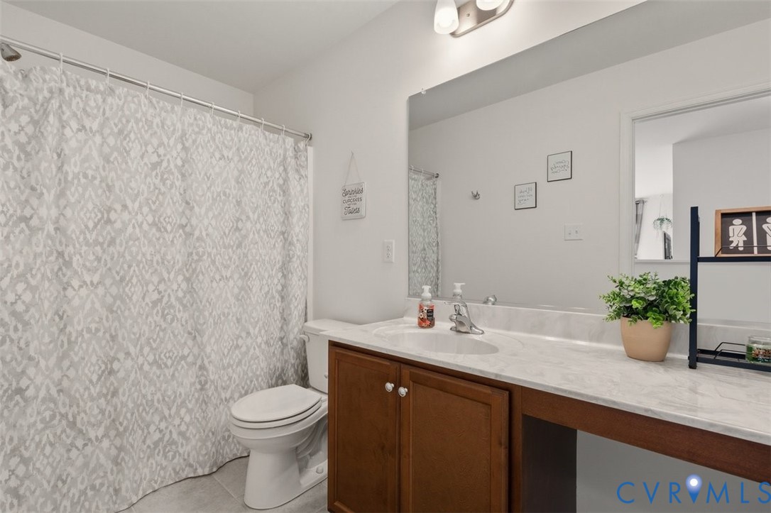 12813 Deep Wl Road Midlothian, VA 23112 - Photo 27 of 35 a bathroom with a granite countertop sink a toilet and a mirror