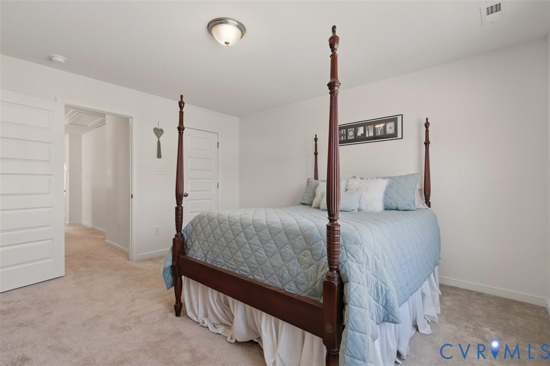 12813 Deep Wl Road Midlothian, VA 23112 - Photo 28 of 35 a bedroom with a bed and a walk in closet