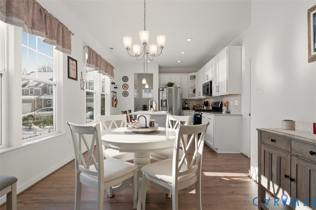 12813 Deep Wl Road Midlothian, VA 23112 - Photo 6 of 35 a view of a dining room with furniture a chandelier and wooden floor
