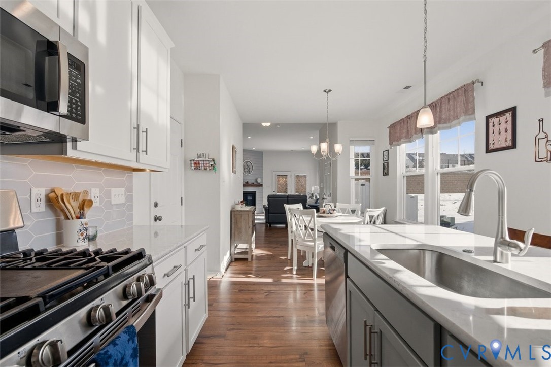 12813 Deep Wl Road Midlothian, VA 23112 - Photo 10 of 35 a kitchen with stainless steel appliances granite countertop a sink stove and refrigerator