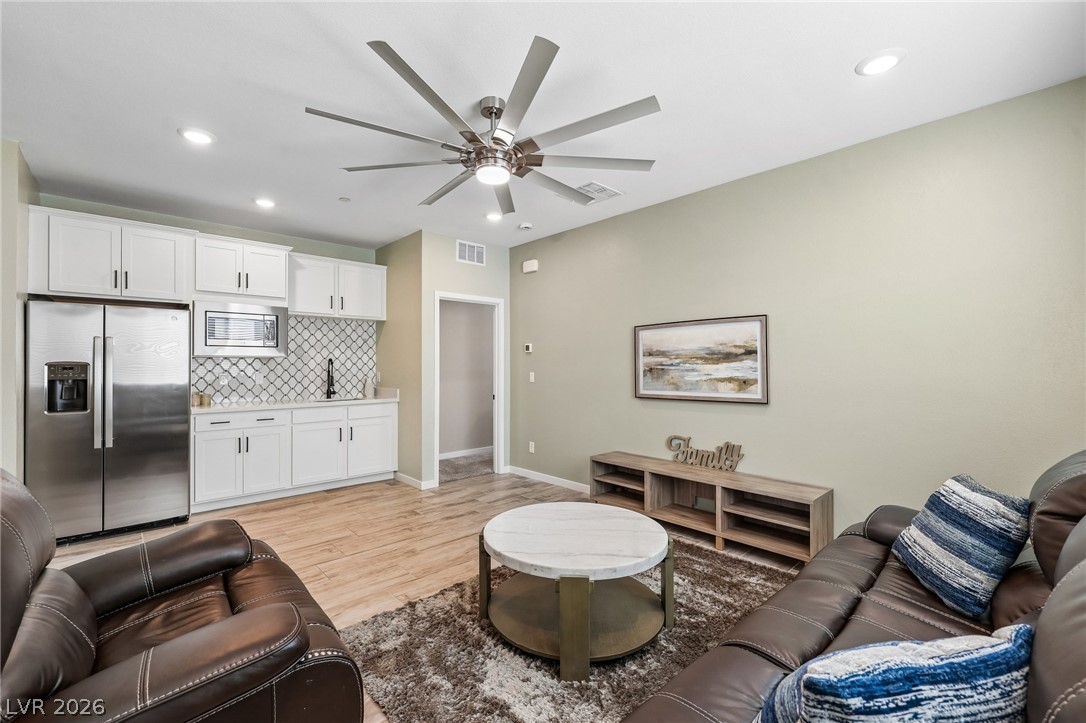 194 Viento Ridge Street Henderson, NV 89012 - Photo 19 of 72 Gleaming hardwood floors and a handy wet bar anchor this versatile open living space.