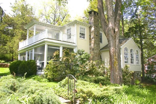 85 Cedar Lane Ridgefield, CT 06877 - Photo 1 of 1 a front view of a house with a yard and plants