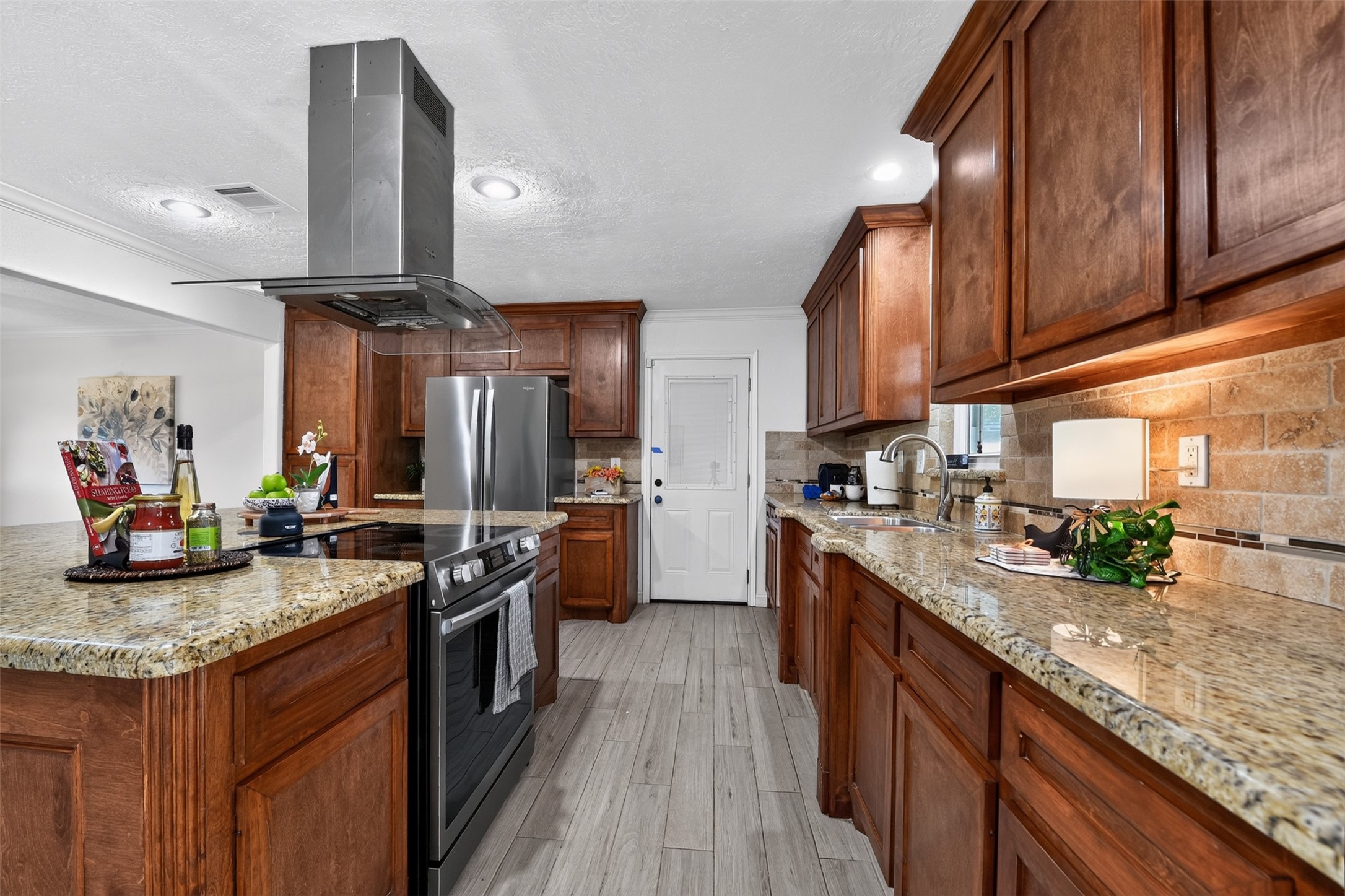 10407 Winding Trail Road La Porte, TX 77571 - Photo 11 of 40 The kitchen shines with an oversized island and modern stainless-steel appliances