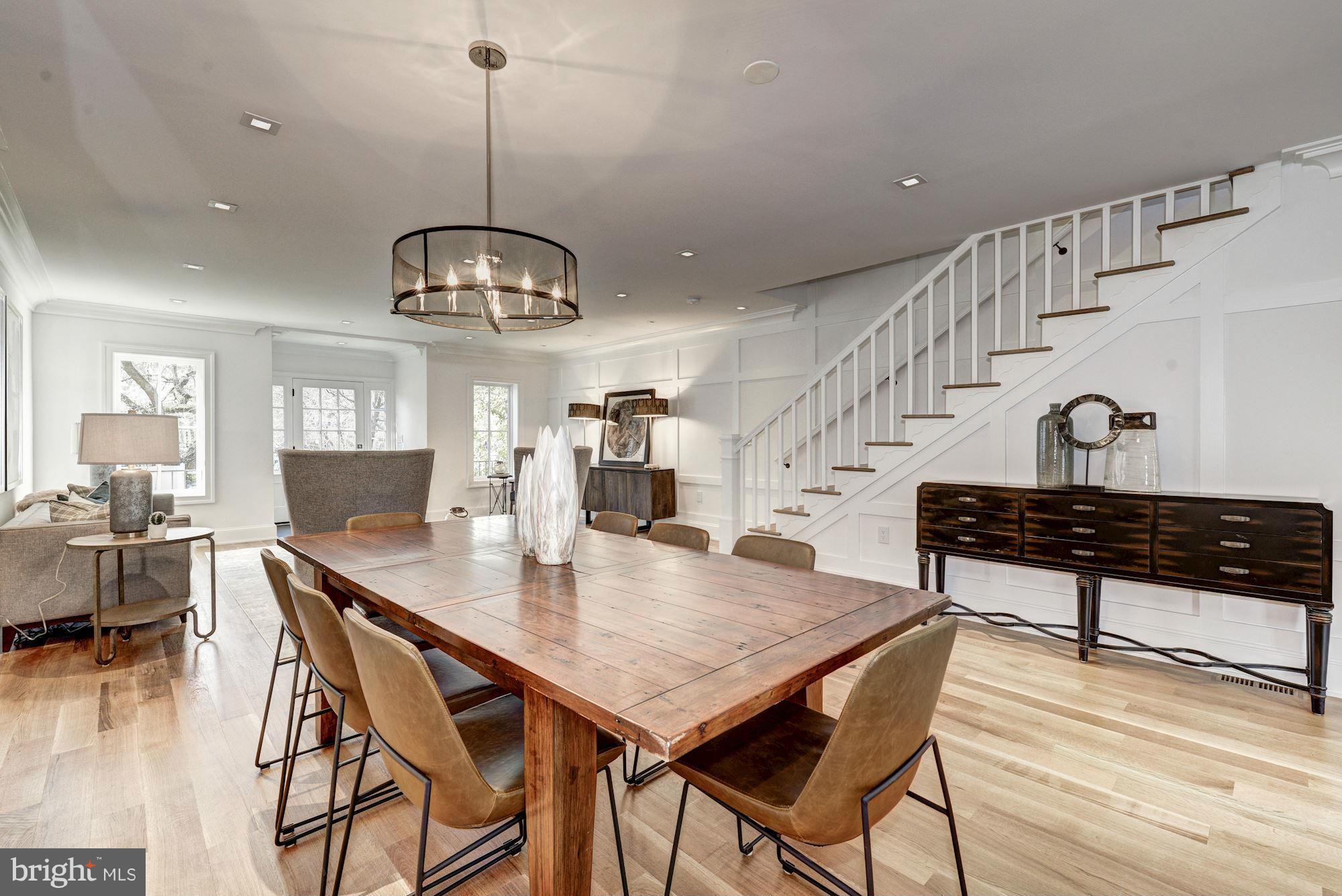 3713 Reservoir Road Northwest Washington, DC 20007 - Photo 7 of 30 a view of a dining room and livingroom with furniture wooden floor a chandelier