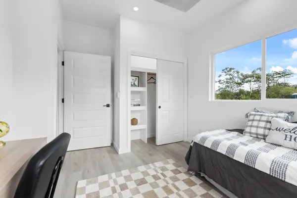 a bedroom with a bed and a chandelier
