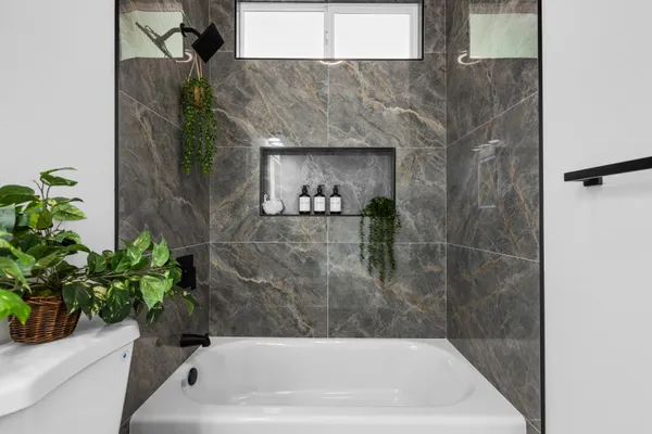 a bath tub sitting in a bathroom next to a white tub