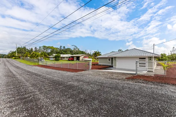 a view of a house with a yard and a garage