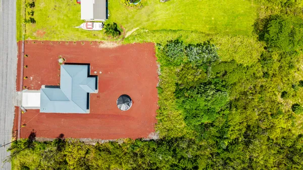 an aerial view of a house with a yard