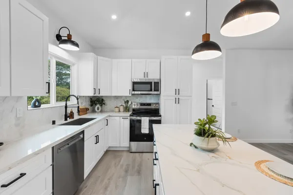 a kitchen with a sink stainless steel appliances and cabinets