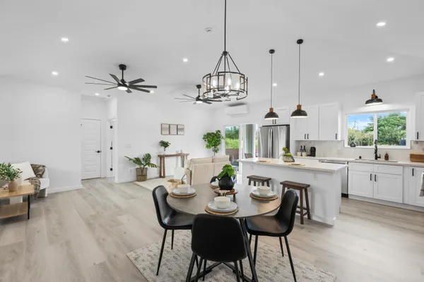 a view of a dining room with furniture and chandelier