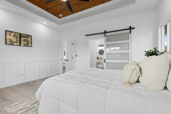 a bedroom with a bed and a chandelier